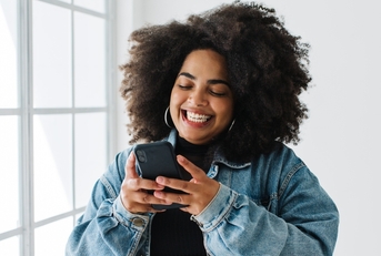 Smiling woman using her phone