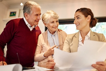 senior couple consulting female lawyer