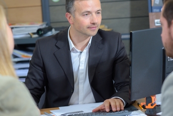 Bank teller helping his clients
