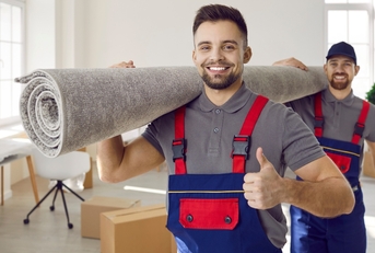 movers carrying carpet