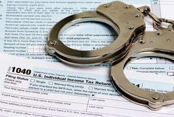 handcuffs over Income tax return documents