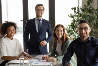 multi ethnic colleagues posing at work