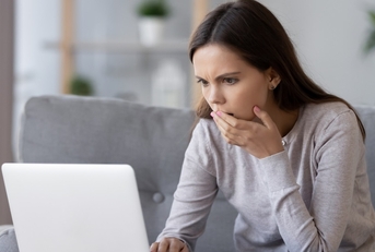 stressed woman reading bad news online