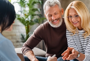 senior couple consulting female finance advisor