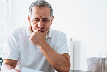 stressed senior man reviewing bills