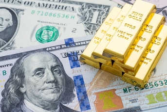 Gold bars on US dollar banknotes