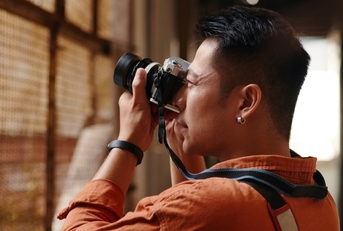 asian male photographer photographing abandoned buildings