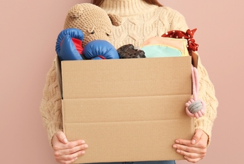 Woman holding box of unwanted stuff