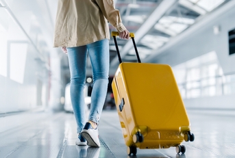 woman with luggage in airport