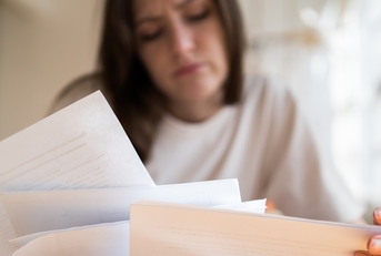 documents in the womans hands