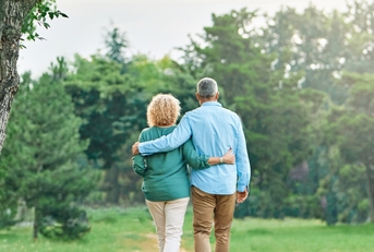 senior couple walking in outdoor park