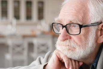 depressed senior man sitting on sofa