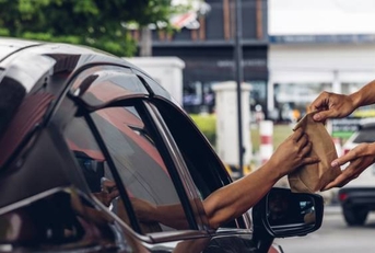 person receiving in fast food drive thru window