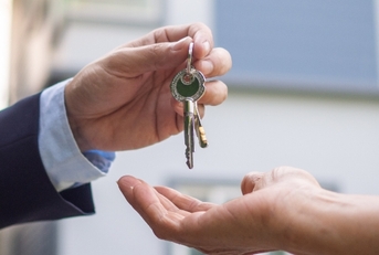 Home buyer taking keys from sellers