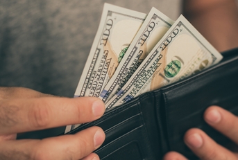 man looks in the wallet