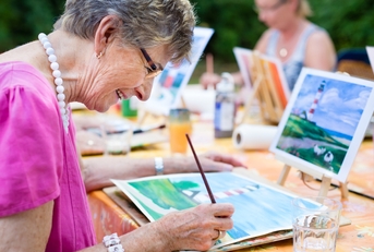 senior woman smiling while drawing
