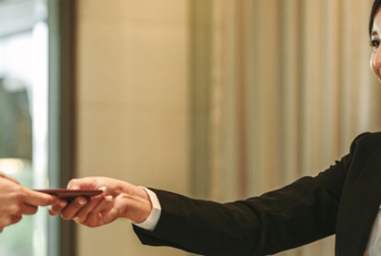 receptionist attending hotel guest