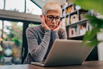 stressed senior woman using laptop