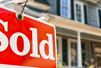 Sold Sign board outside Suburban Home