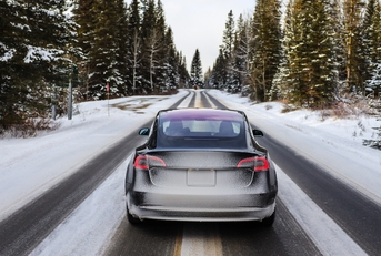 electric car driving mountains snow