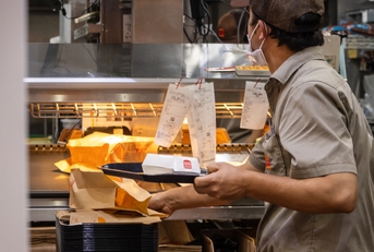 worker preparing takeaway food