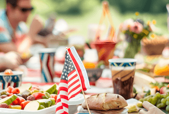 A group of friends sit at a picnic table to celebrate the Fourth of July.