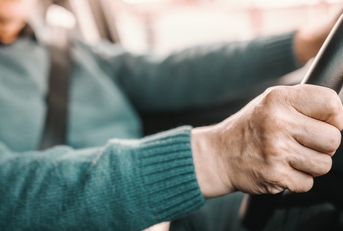 man steering while driving car