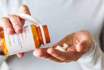 sick woman taking pills