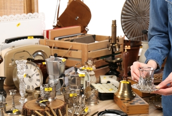 woman buying glassware at garage sale