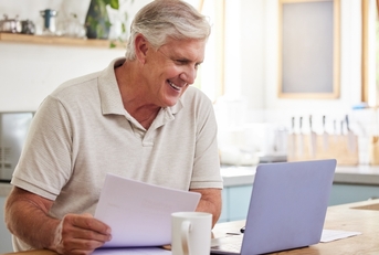 happy senior male investor reading email