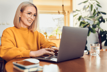 A woman uses her laptop at home.