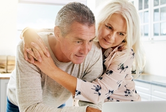 senior couple using laptop