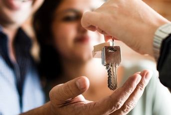 cheerful couple with keys