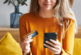 Happy woman shopping online with credit card