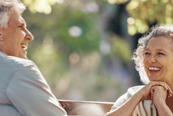 senior couple on bench at park