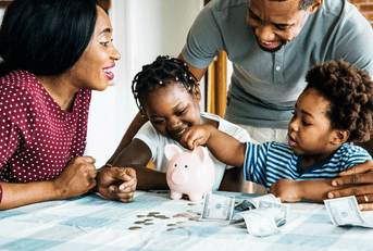 A family gathers at the table, counting money from a piggy bank.