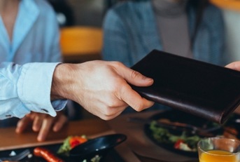 man paying bill with cash