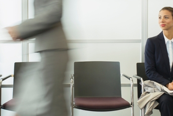 businesswoman sitting in busy waiting area
