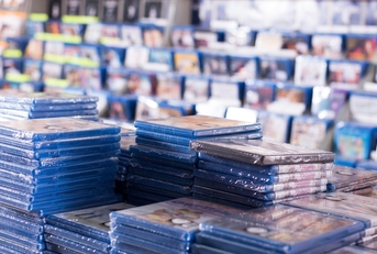 cds and dvds on piles at store
