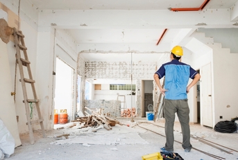 male worker inspecting house renovation
