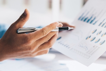 Businessman analyzing graphs at work