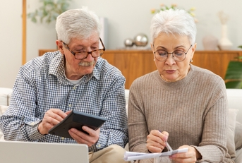 senior couple reviweing budget together