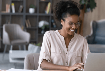 Woman types on her computer. 