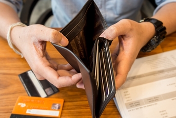 man showing empty wallet debt concept