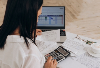 woman calculates utility expenses 