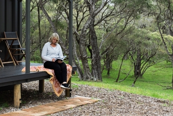 reading a book on the deck