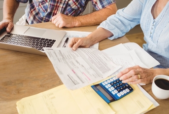 Senior couple reviewing bills together