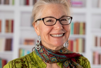 graceful senior woman smiling at library