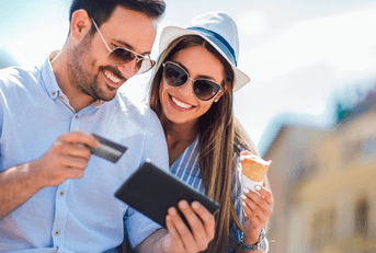 A couple pays their bill on a tablet.