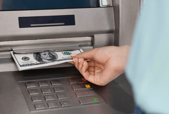 woman getting money from ATM